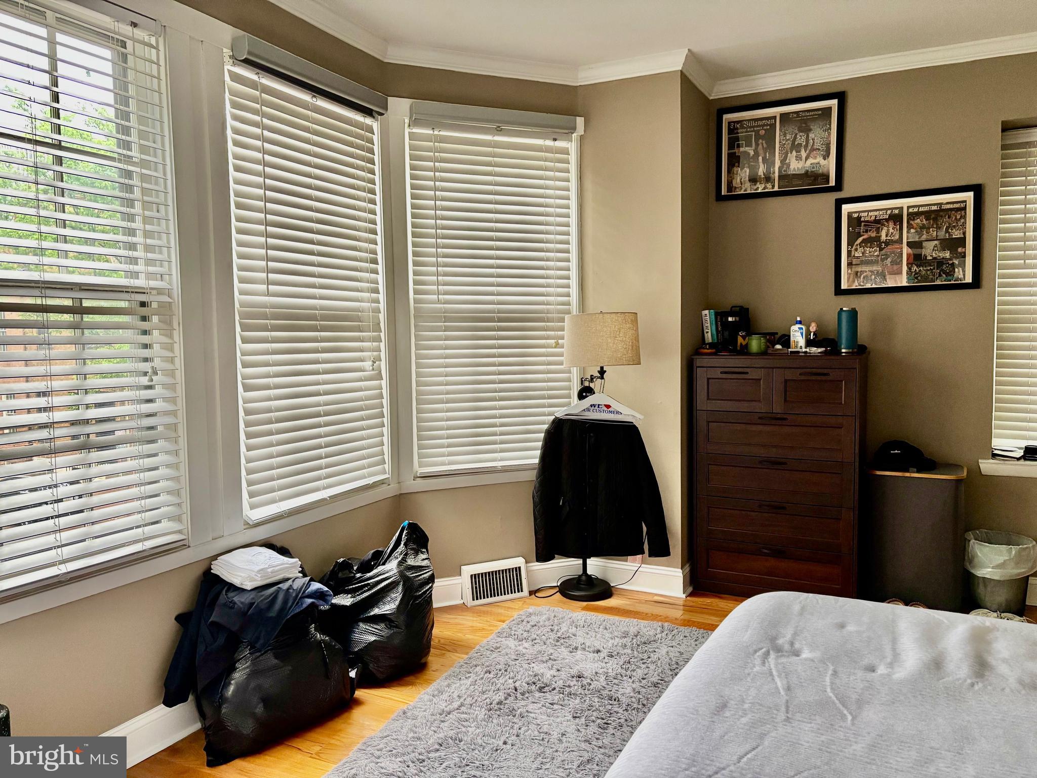 300 Lombard Street Philadelphia, PA 19147 - Photo 11 of 14 a bedroom with a bed and wooden floor