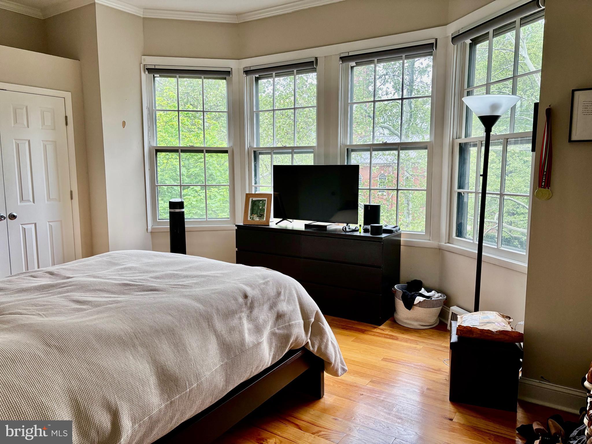 300 Lombard Street Philadelphia, PA 19147 - Photo 12 of 14 a bedroom with a bed window and a flat tv screen