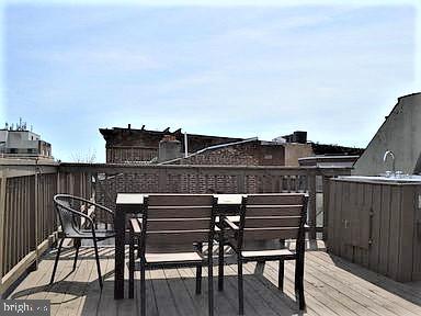 300 Lombard Street Philadelphia, PA 19147 - Photo 13 of 14 a view of a roof deck with table and chairs with wooden floor and fence