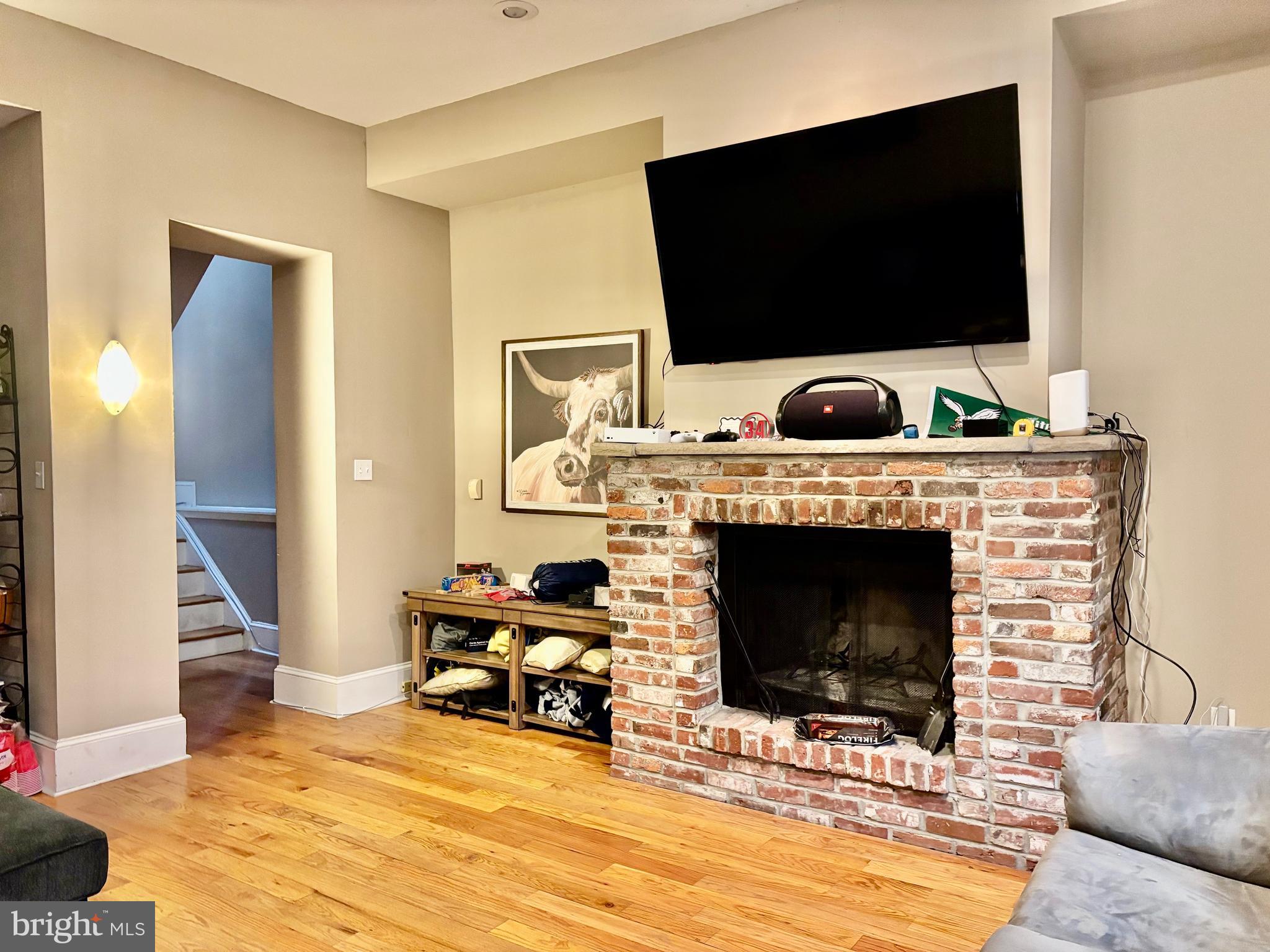300 Lombard Street Philadelphia, PA 19147 - Photo 6 of 14 a living room with furniture a flat screen tv and a fireplace