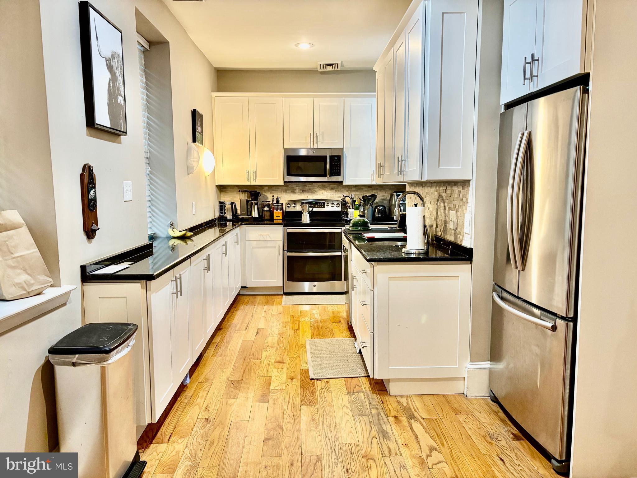 300 Lombard Street Philadelphia, PA 19147 - Photo 7 of 14 a kitchen with granite countertop a refrigerator stove and sink