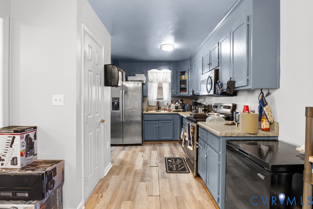 4025 Frye Terrace Colonial Heights, VA 23834 - Photo 6 of 14 Kitchen featuring blue cabinetry, wood-finish floo