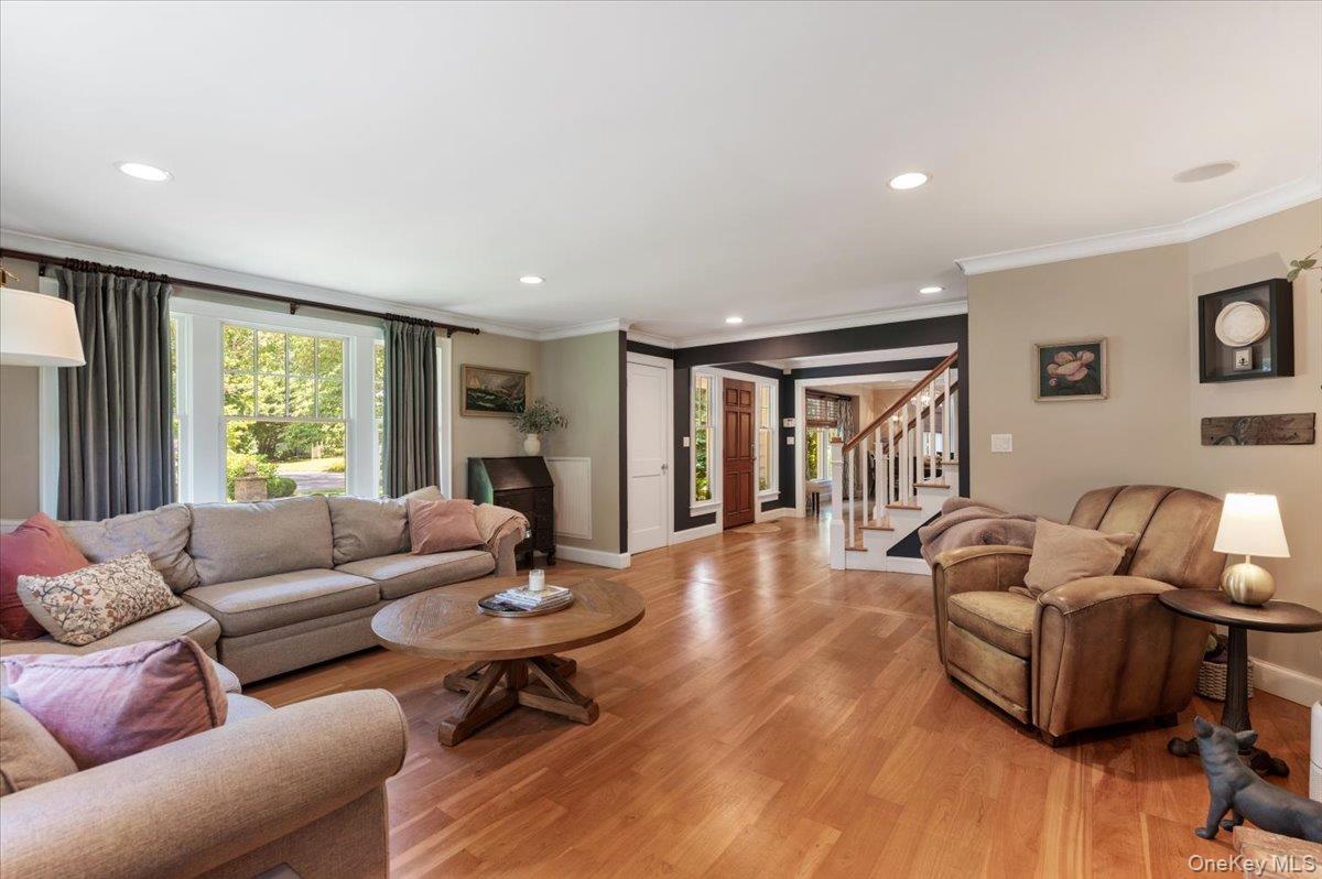 5 Fox Hunt Court Cold Spring Harbor, NY 11724 - Photo 5 of 42 Hardwood flooring throughout a spacious living area featuring recessed lighting and crown molding