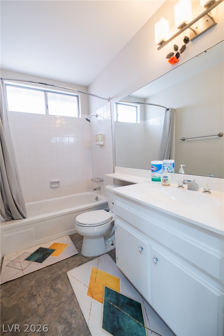 6356 West Viking Road Las Vegas, NV 89103 - Photo 21 of 51 Tiled walls and a spacious vanity with integrated sink define this well-appointed full bath.