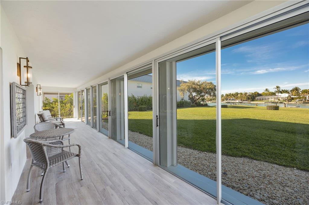 383 Harbour Drive, Unit 101 Naples, FL 34103 - Photo 11 of 30 Sliding doors open directly to lawn/Bay Area.