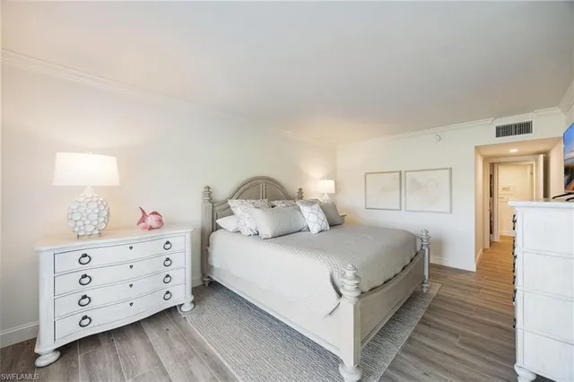 a bedroom with a bed and a dresser in it