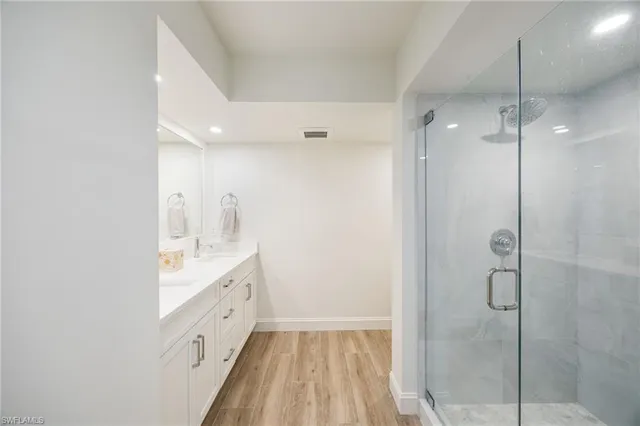 a spacious bathroom with a shower and a sink
