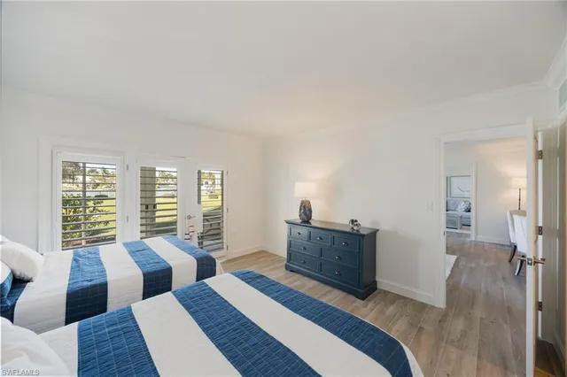 a bedroom with furniture and a large window