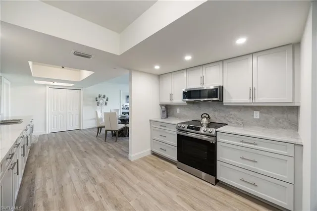 a kitchen with stainless steel appliances granite countertop a refrigerator and a sink