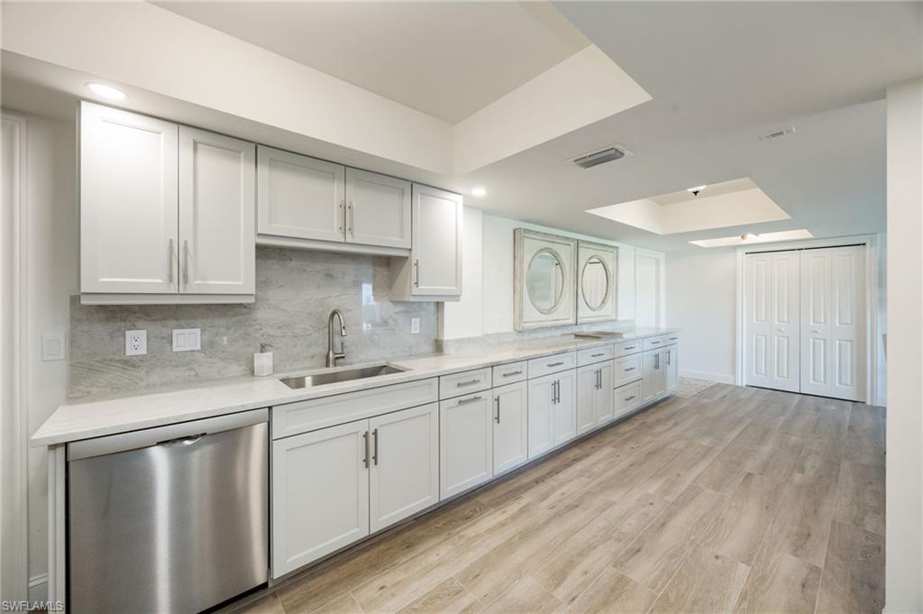 383 Harbour Drive, Unit 101 Naples, FL 34103 - Photo 6 of 30 Kitchen offers massive storage and serving bar.