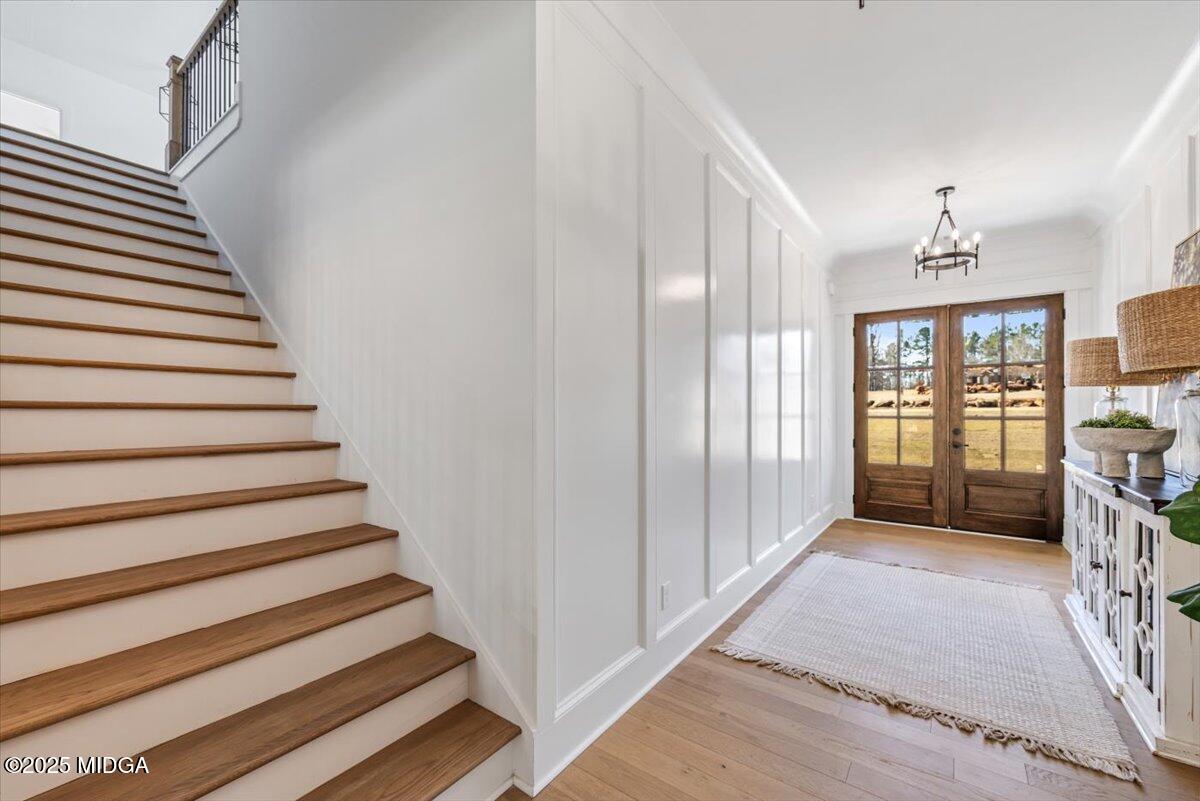 104 Piedmont Circle Forsyth, GA 31029 - Photo 19 of 42 a view of entryway with stairs and wooden floor
