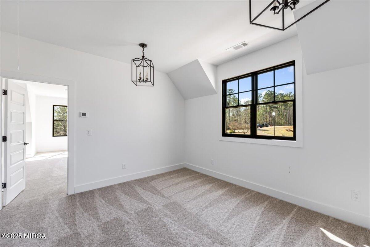 104 Piedmont Circle Forsyth, GA 31029 - Photo 23 of 42 an empty room with windows and cabinet