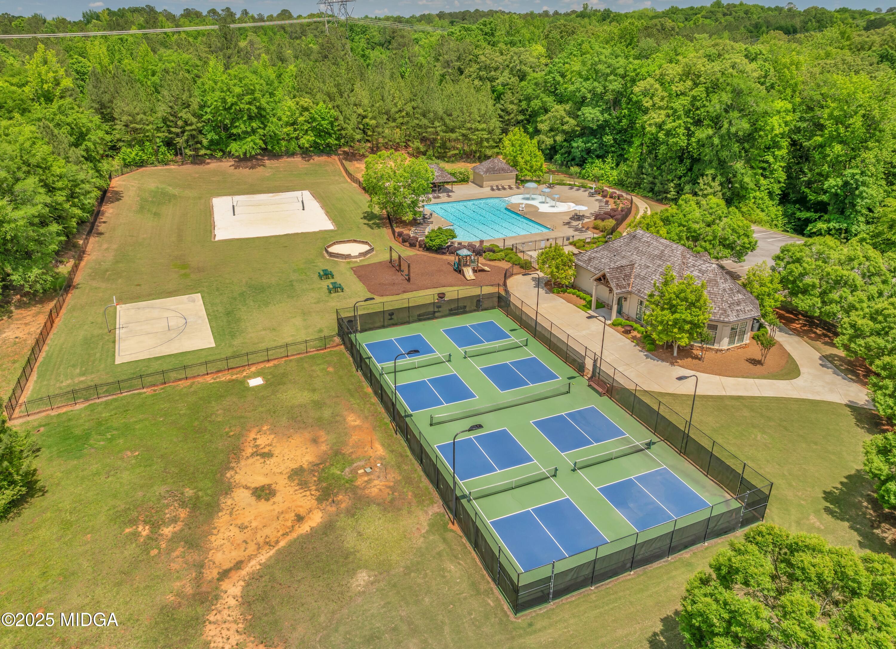 104 Piedmont Circle Forsyth, GA 31029 - Photo 40 of 42 a aerial view of a swimming pool with lawn chairs and large trees
