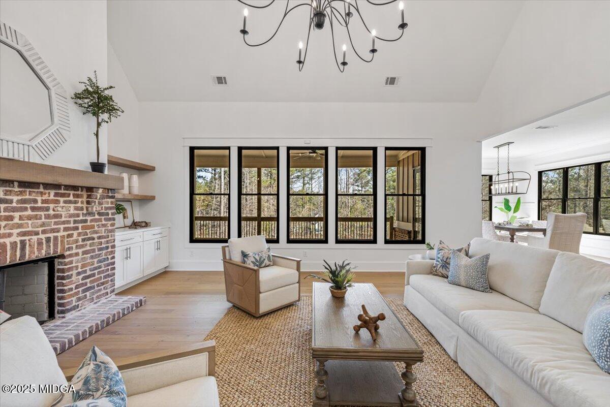 104 Piedmont Circle Forsyth, GA 31029 - Photo 5 of 42 a living room with furniture fireplace and a large window