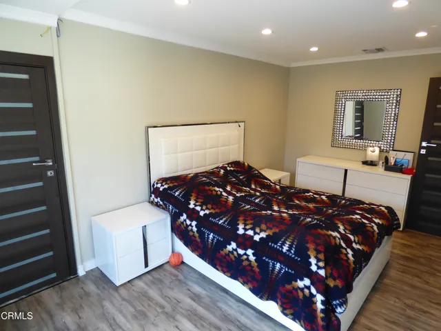 a bed room with a bed window and a mirror