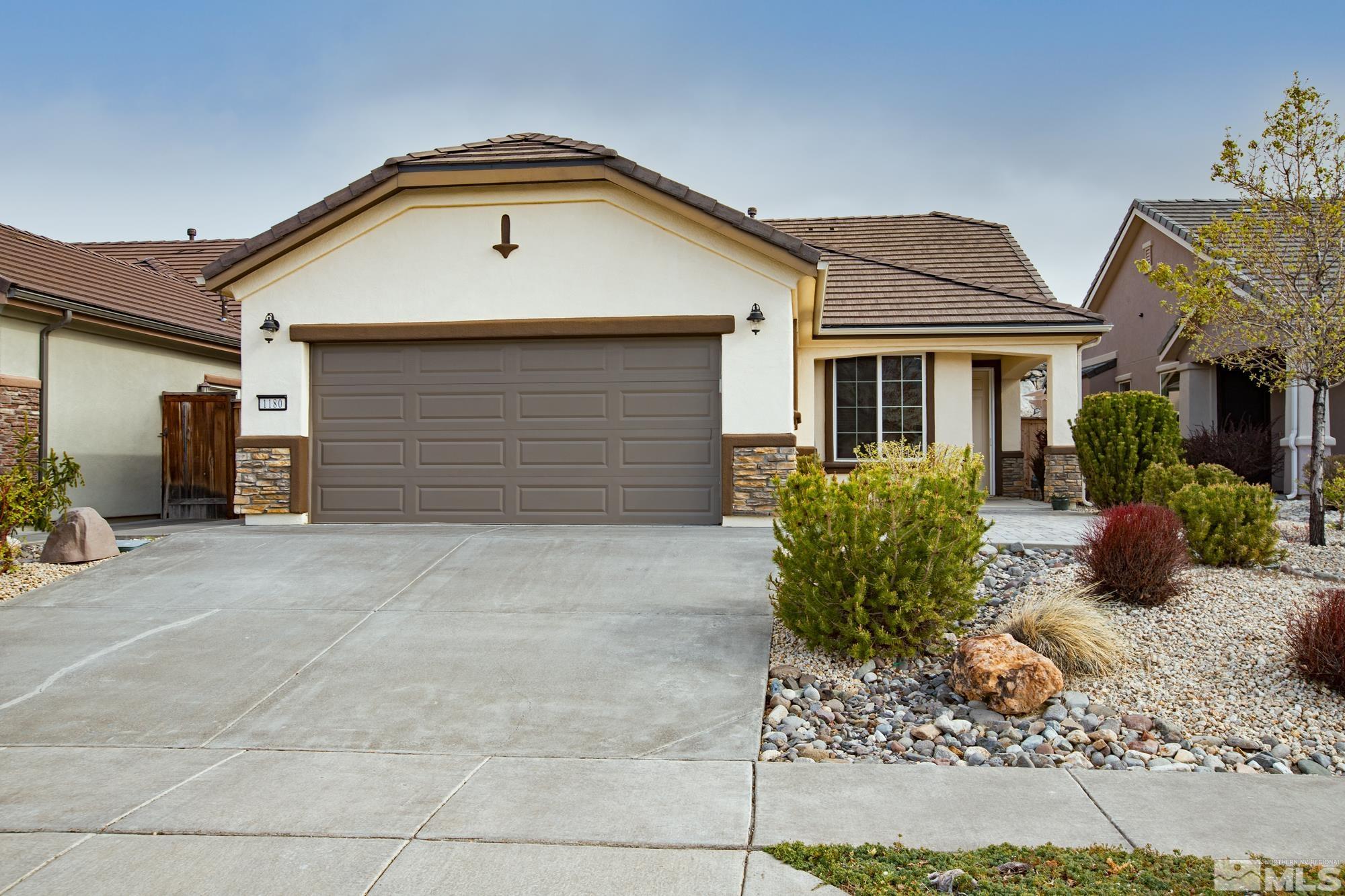 1180 Meridian Ranch Drive Reno, NV 89523 - Photo 1 of 28 a front view of a house with garden