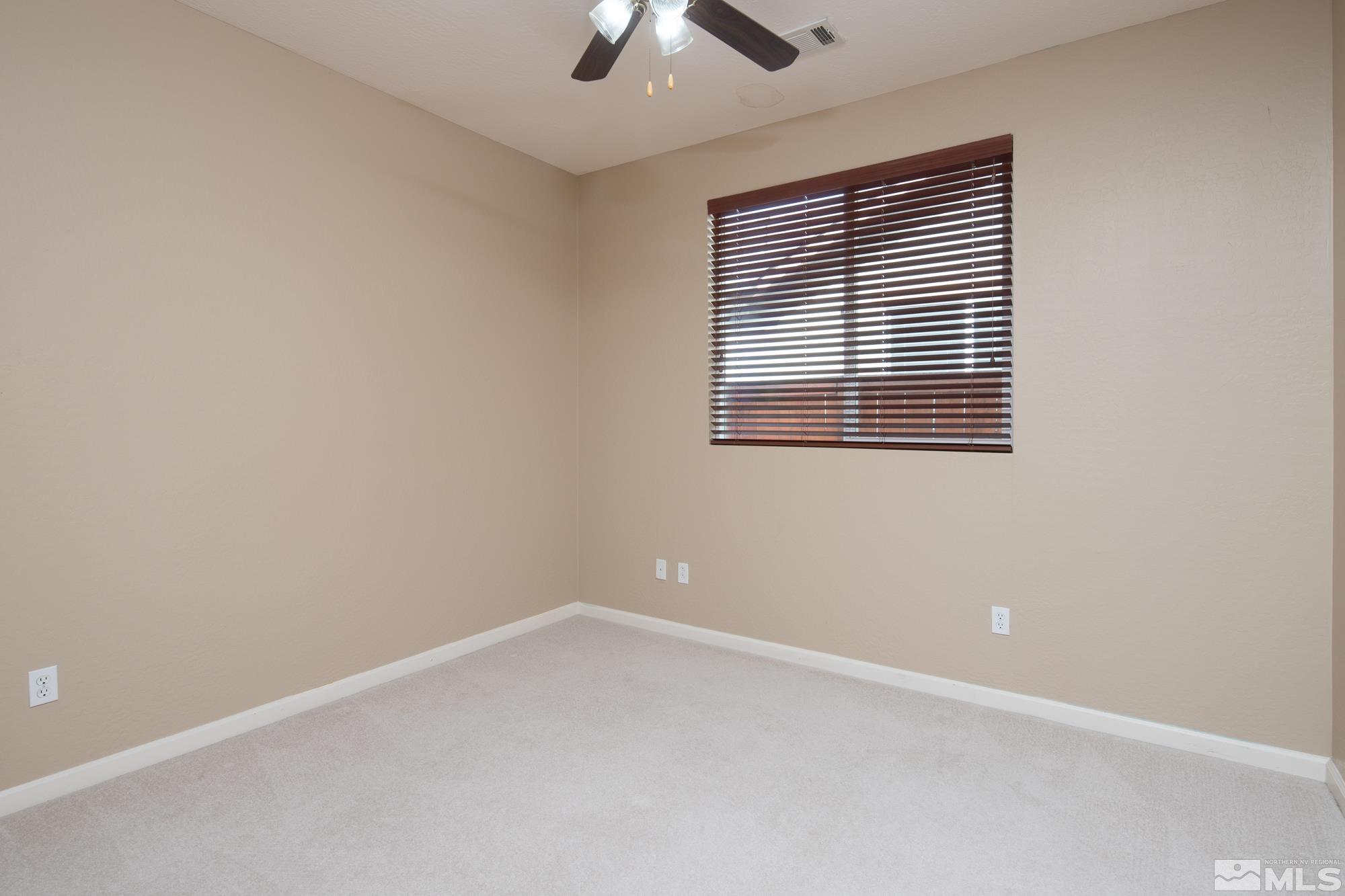 1180 Meridian Ranch Drive Reno, NV 89523 - Photo 12 of 28 an empty room with a window and a ceiling fan