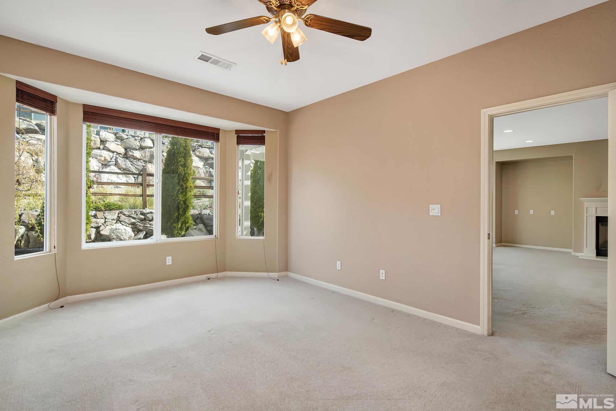 1180 Meridian Ranch Drive Reno, NV 89523 - Photo 17 of 28 an empty room with windows and fan