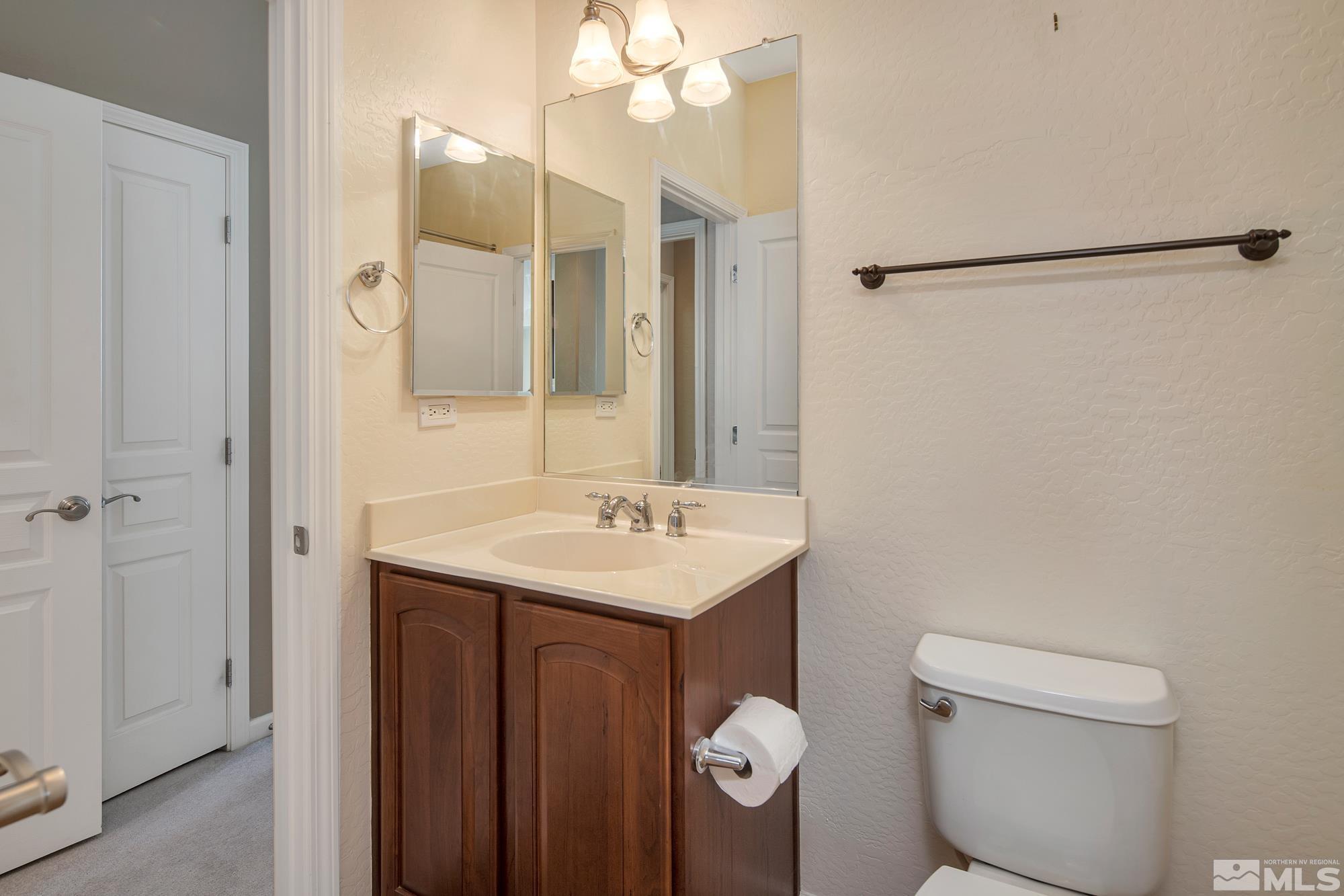 1180 Meridian Ranch Drive Reno, NV 89523 - Photo 22 of 28 a bathroom with a sink a toilet a large mirror and shower