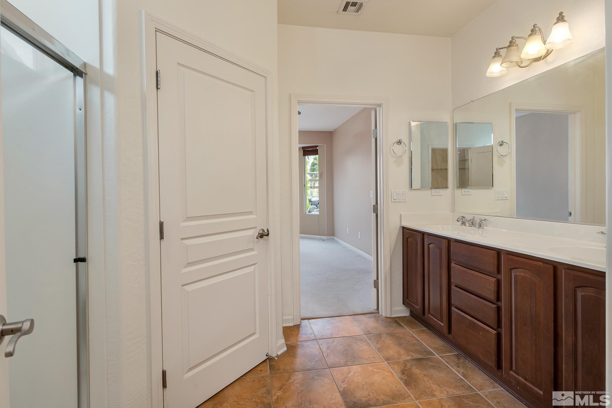 1180 Meridian Ranch Drive Reno, NV 89523 - Photo 23 of 28 a bathroom with a sink vanity and a mirror