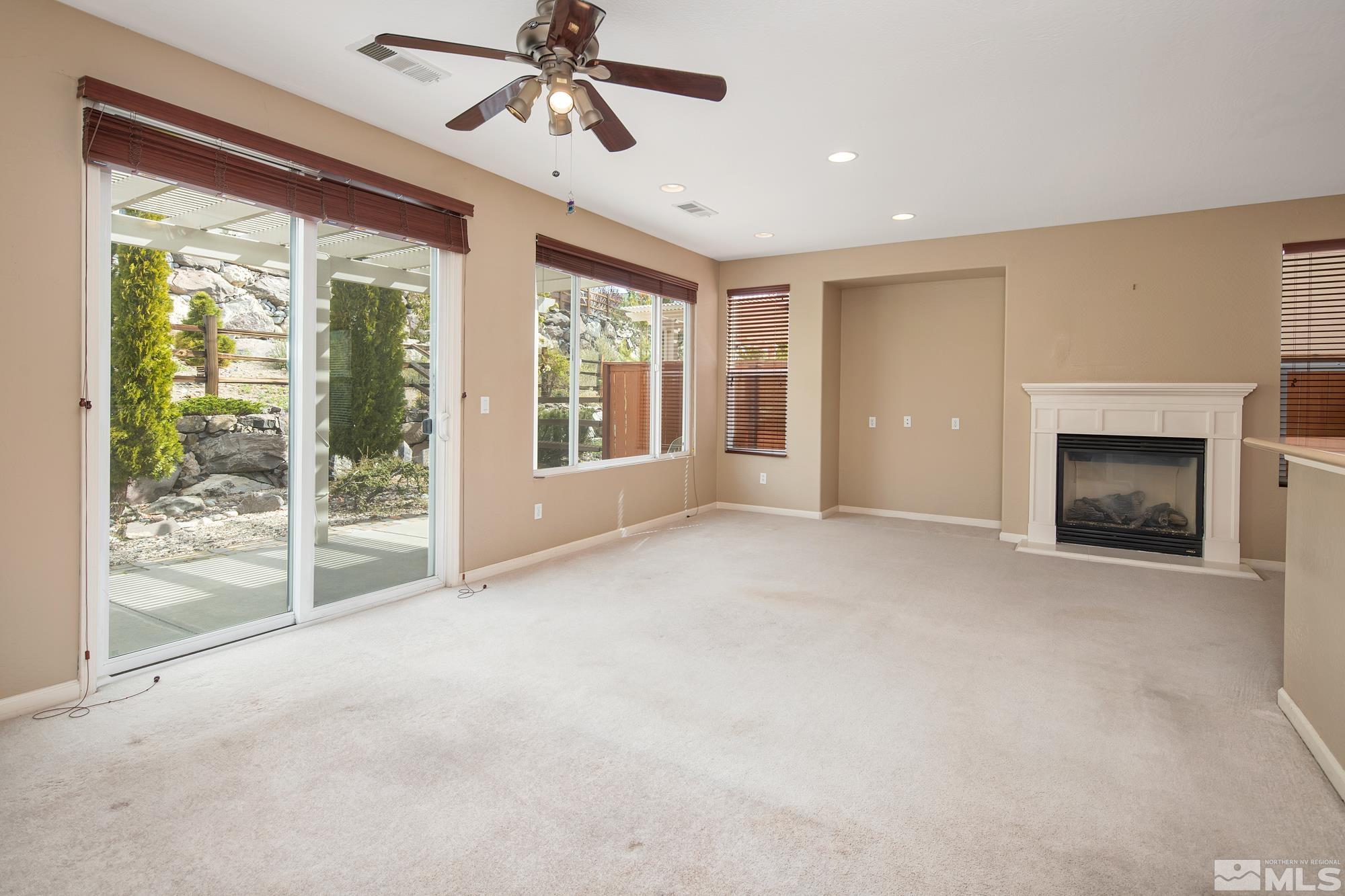 1180 Meridian Ranch Drive Reno, NV 89523 - Photo 3 of 28 a view of an empty room with a fireplace and a window