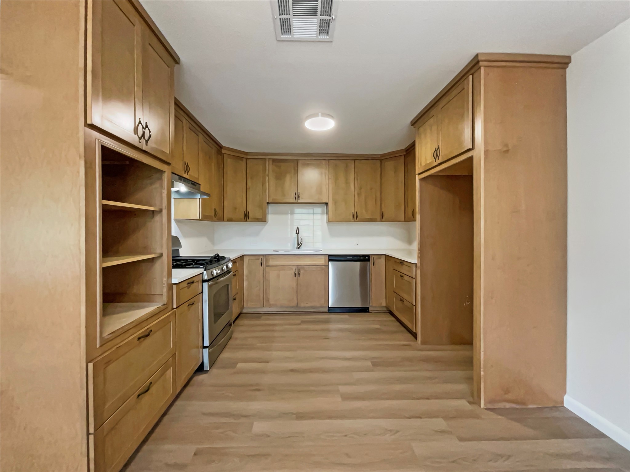 6805 Crystalbrook Drive Austin, TX 78724 - Photo 12 of 31 a kitchen with stainless steel appliances sink a refrigerator and cabinets