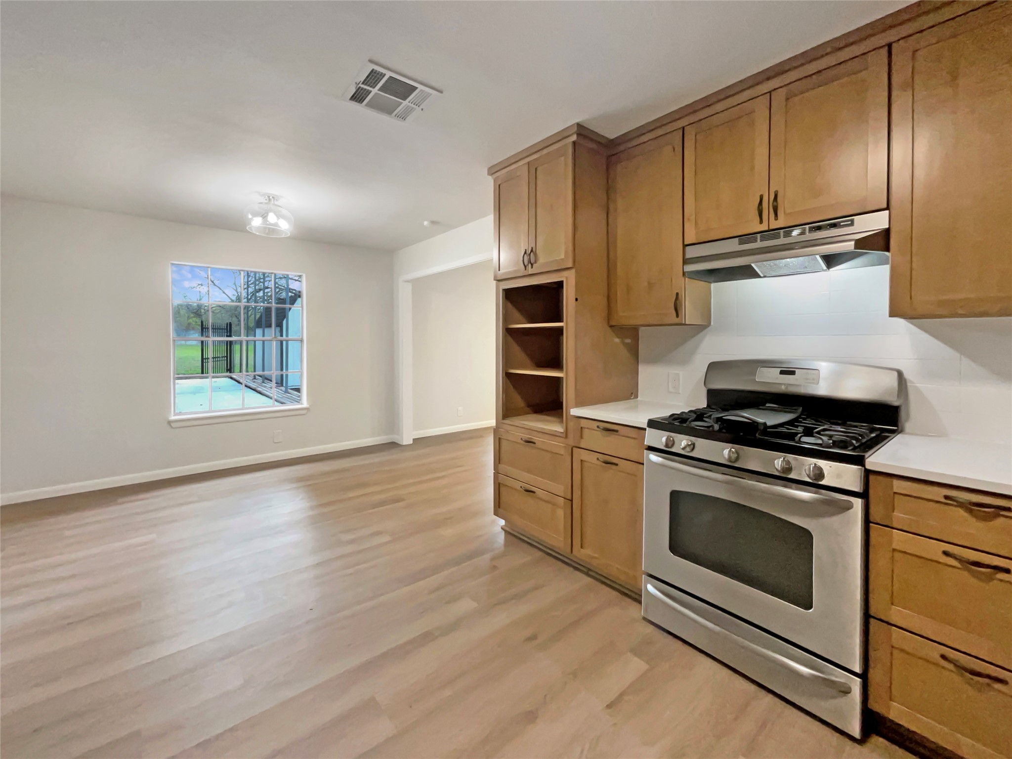 6805 Crystalbrook Drive Austin, TX 78724 - Photo 14 of 31 a kitchen with a stove a sink and a refrigerator
