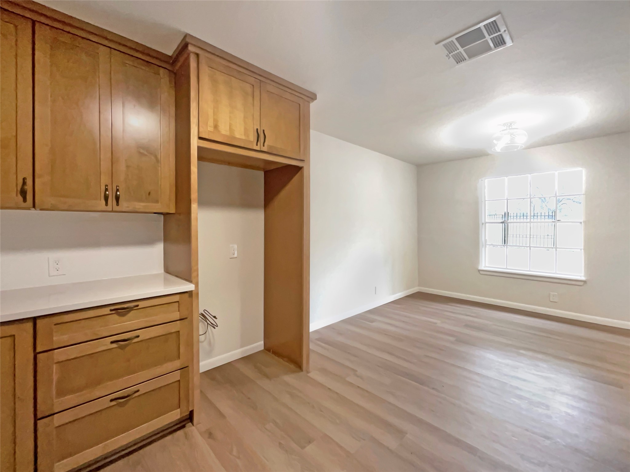 6805 Crystalbrook Drive Austin, TX 78724 - Photo 15 of 31 a view of an empty room with wooden floor and cabinet