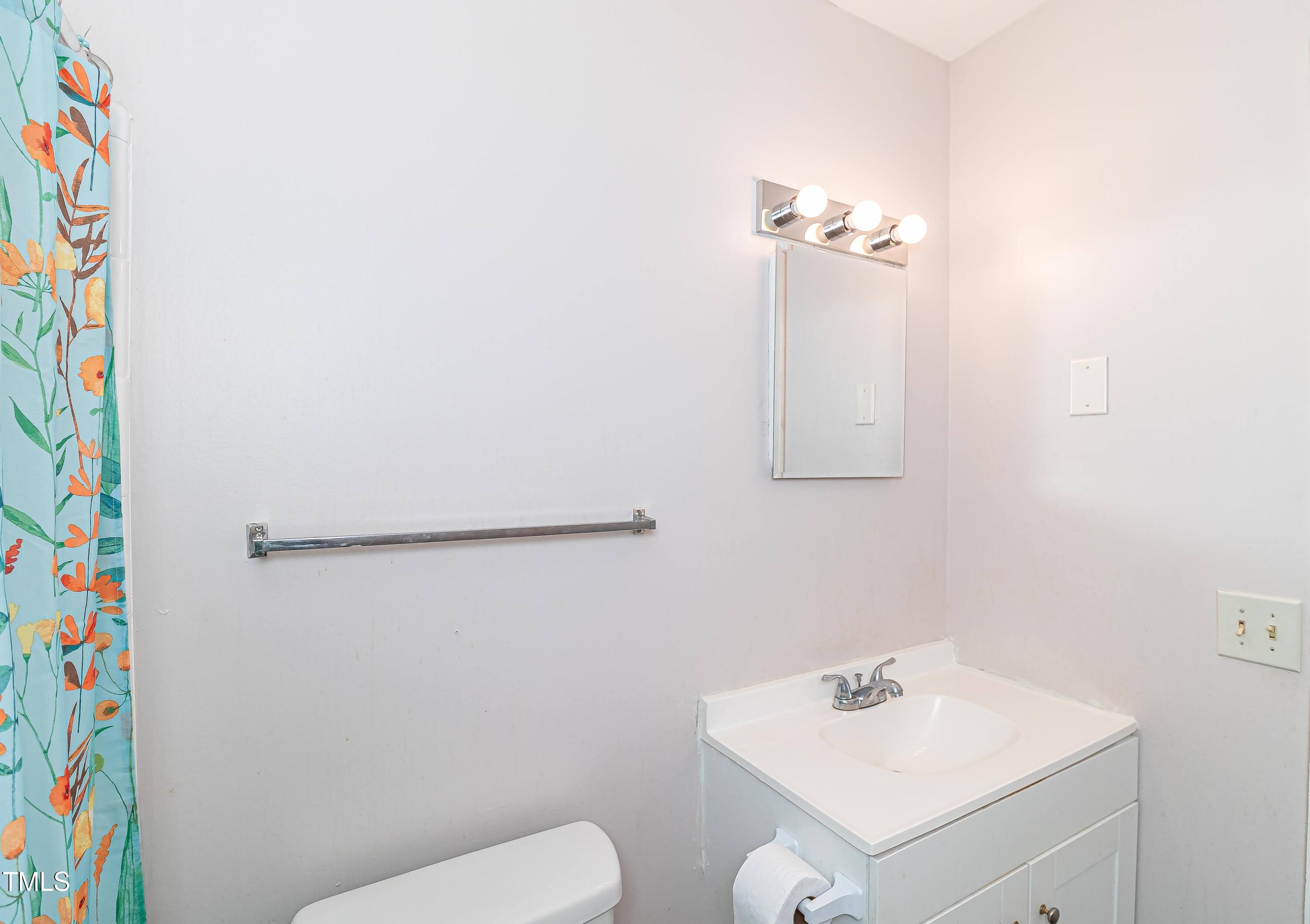 1205 Armstrong Circle Raleigh, NC 27610 - Photo 16 of 31 a bathroom with a sink toilet and vanity