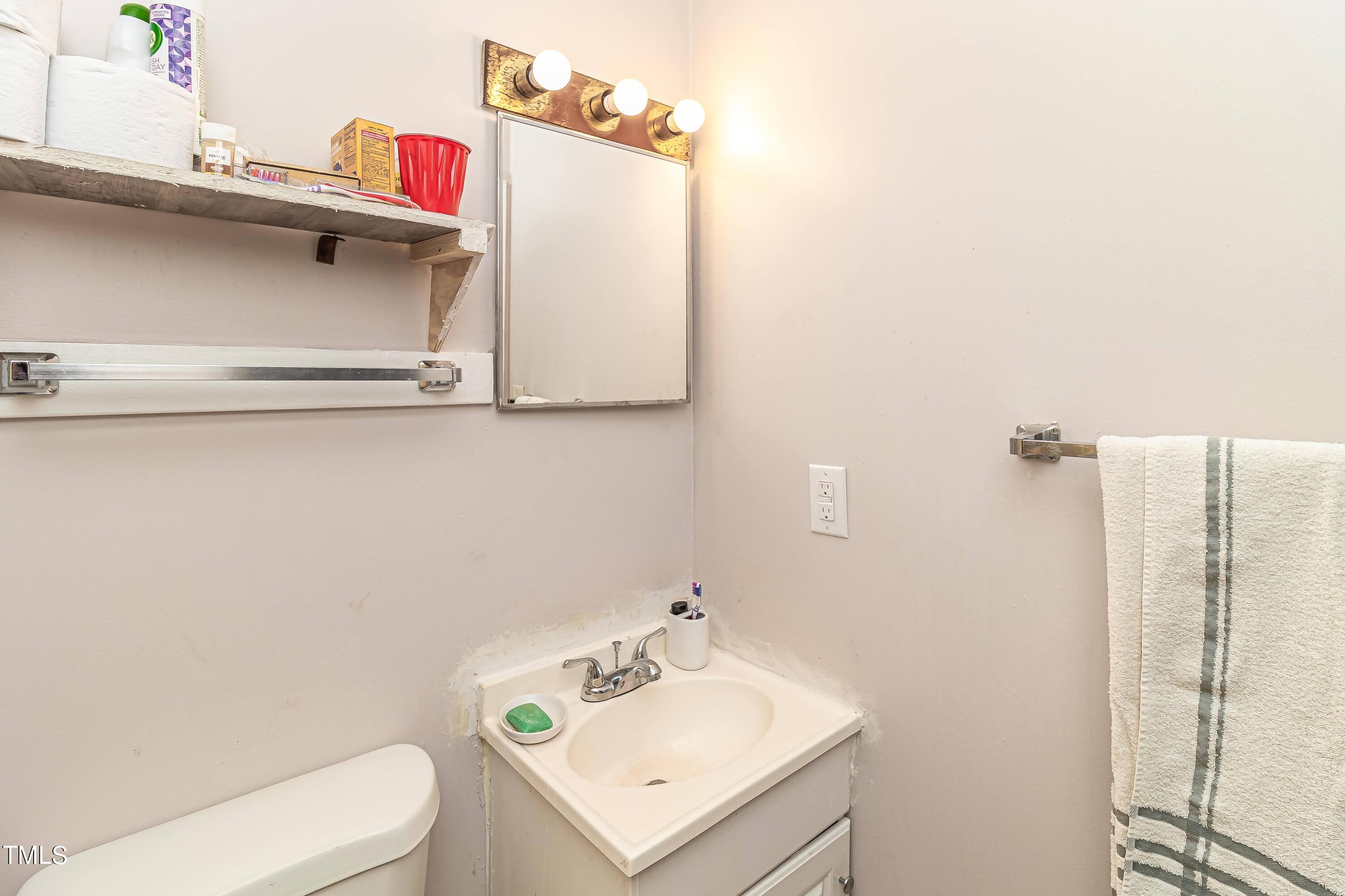 1205 Armstrong Circle Raleigh, NC 27610 - Photo 19 of 31 a bathroom with a sink mirror and toilet