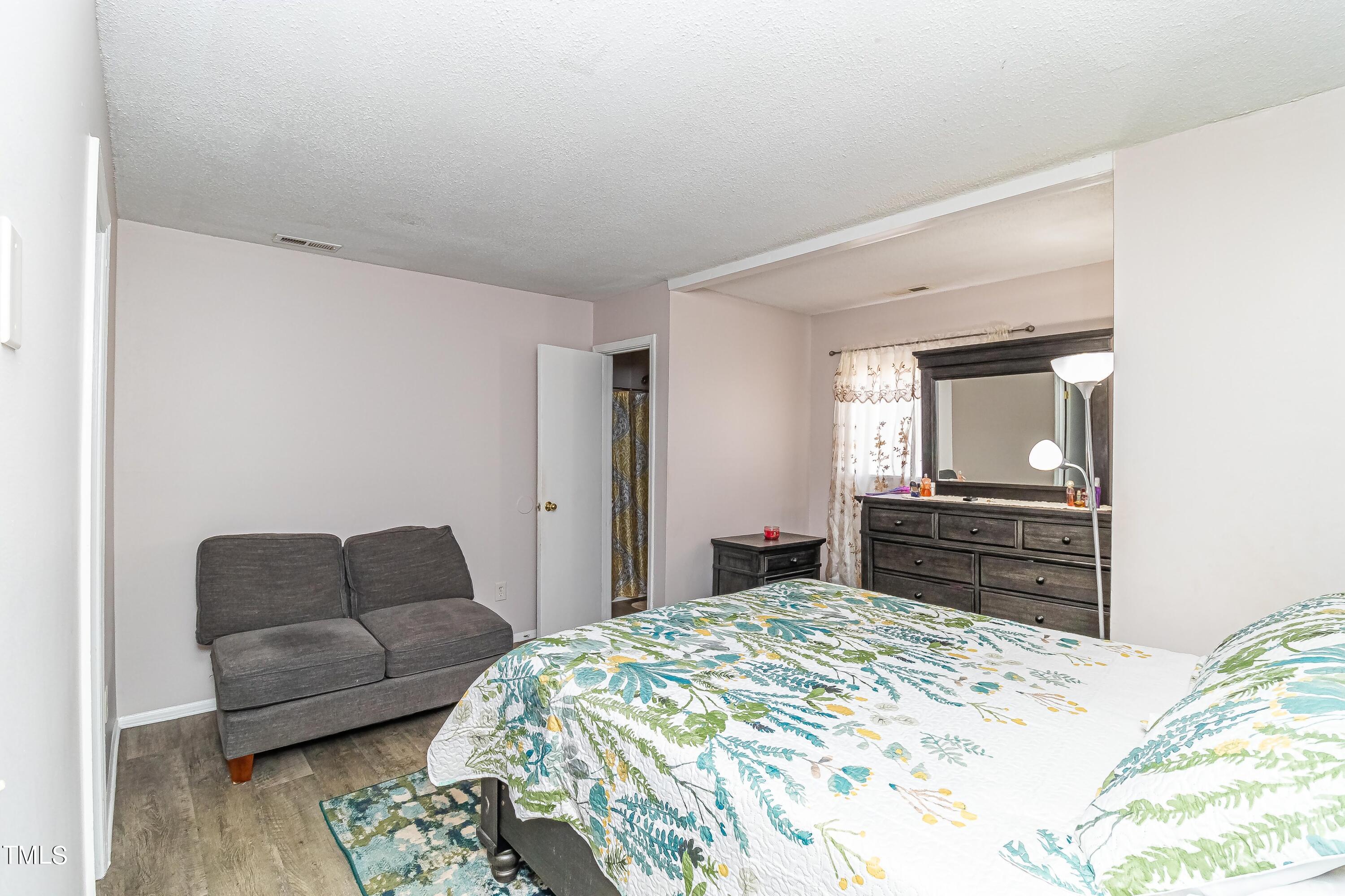 1205 Armstrong Circle Raleigh, NC 27610 - Photo 20 of 31 a bedroom with a bed and a couch