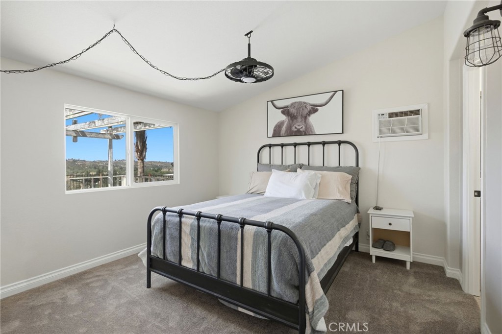 40100 Owl Valley Road Temecula, CA 92592 - Photo 17 of 44 a bedroom with a bed and a window