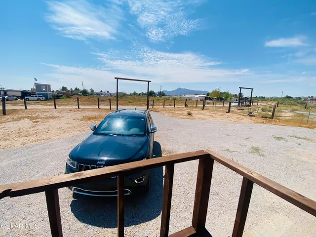 a bathroom with a granite countertop sink a toilet a mirror and shower