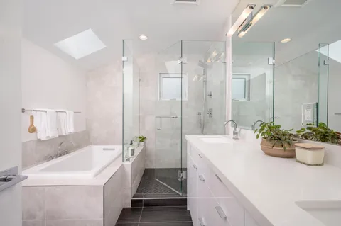 a bathroom with a tub sink and mirror