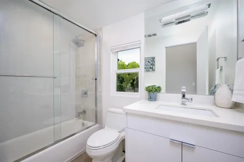a bathroom with a sink toilet and shower
