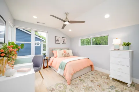 a bedroom with a bed and ceiling fan