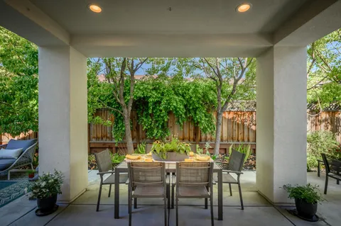a view of a patio with a table and chairs