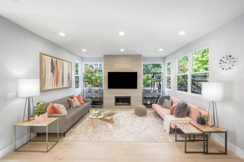 a living room with furniture fireplace and a flat screen tv