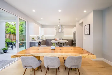 a dining room with furniture and a wooden floor