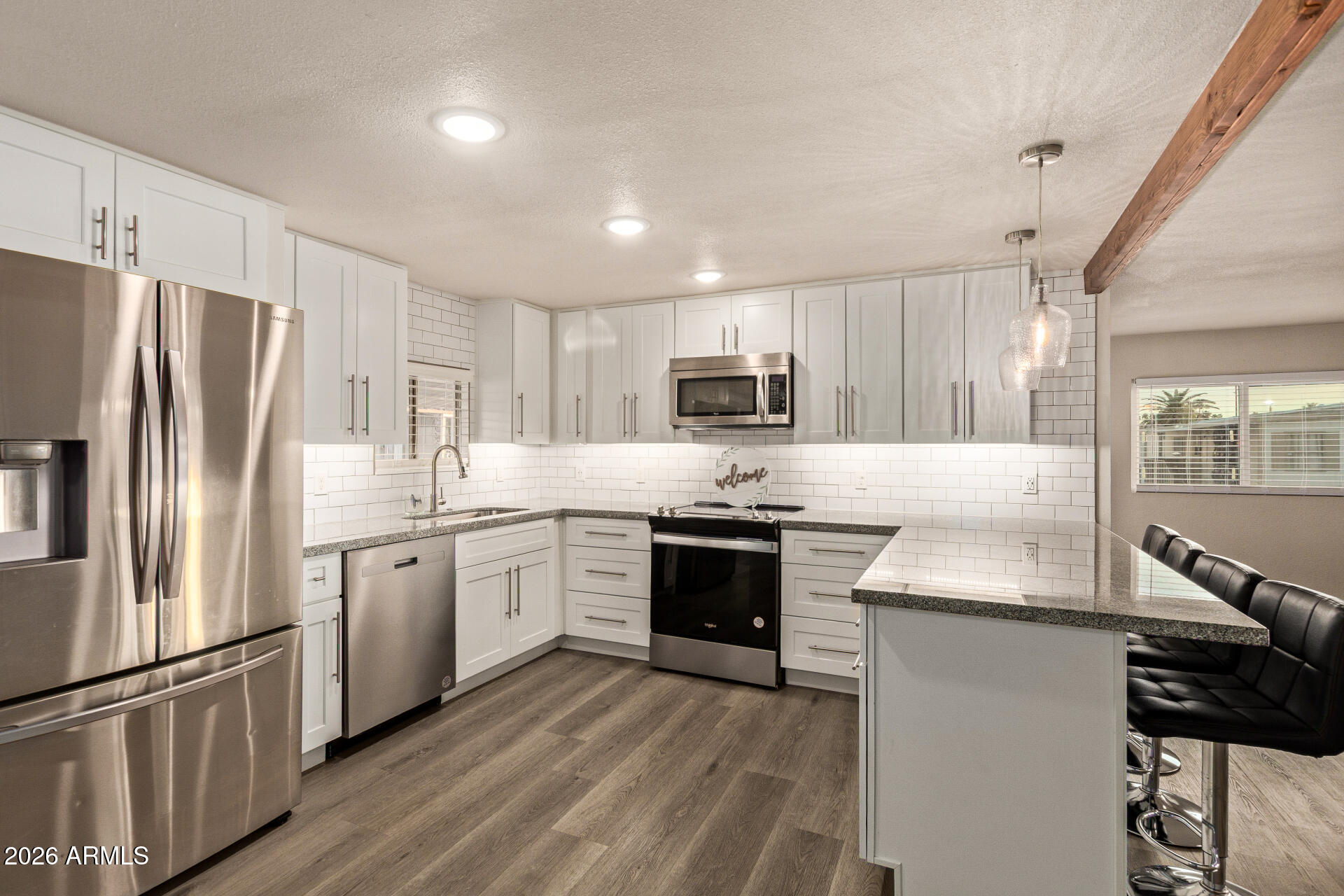 400 West Baseline Road, Unit 312 Tempe, AZ 85283 - Photo 2 of 32 a kitchen with kitchen island granite countertop a refrigerator stove top oven and sink