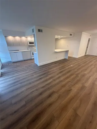 a view of a bedroom with wooden floor