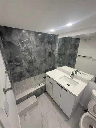 a bathroom with a sink and mirror