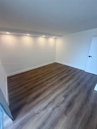 a view of an empty room and wooden floor