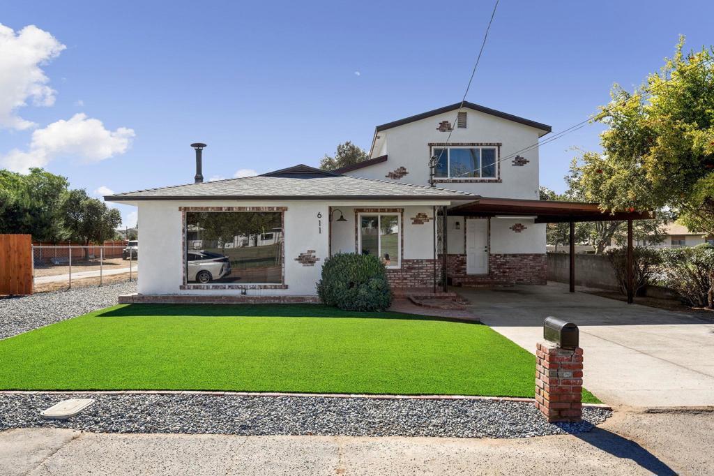 a front view of a house with a garden and yard