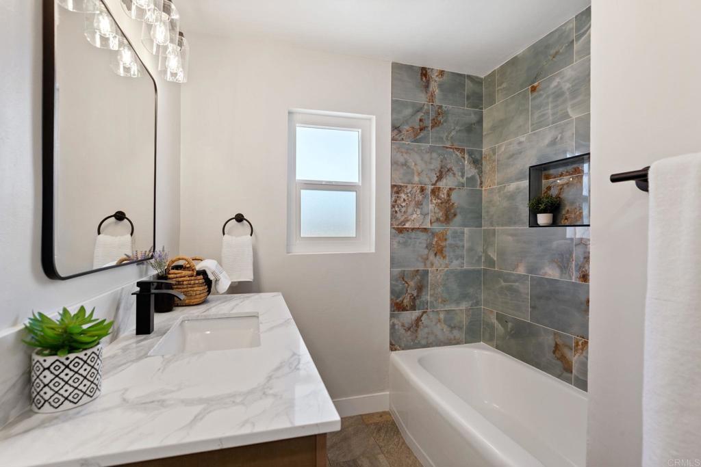 611 9th Street Ramona, CA 92065 - Photo 12 of 39 a bathroom with a tub sink and mirror
