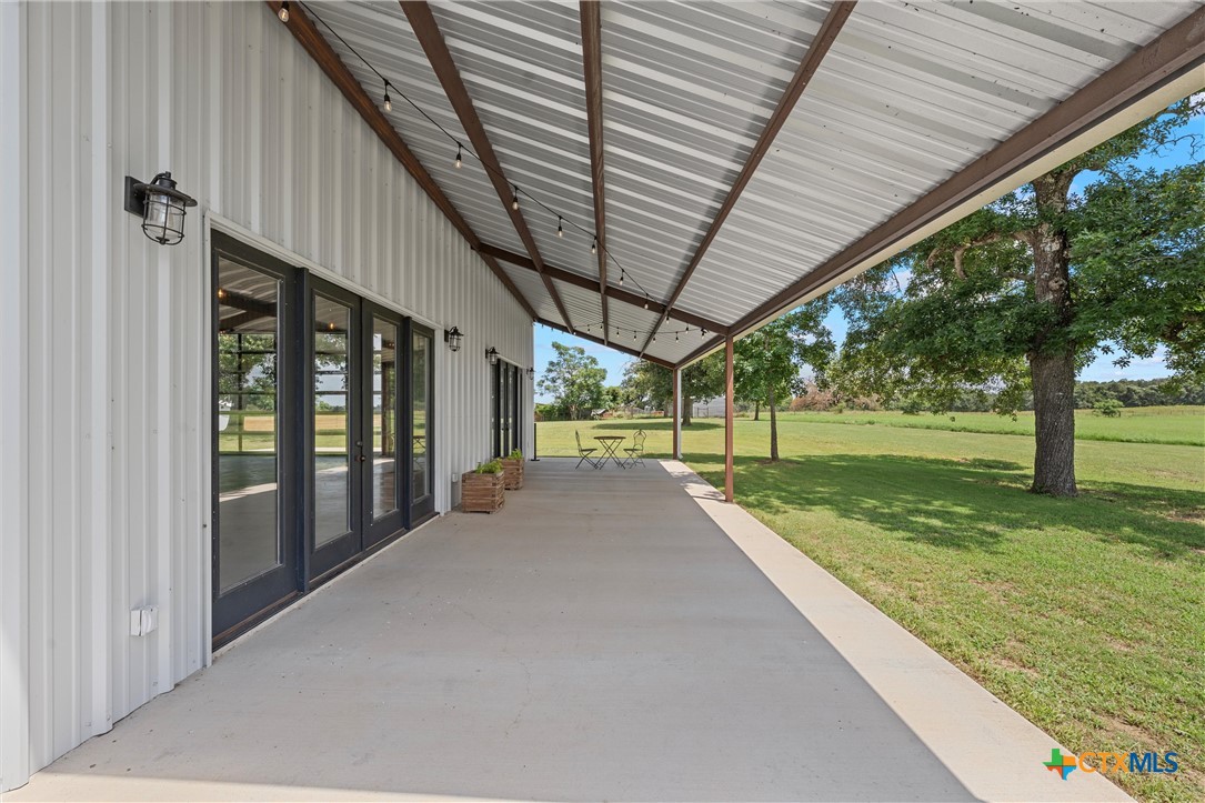 1006 County Road 280 Cameron, TX 76520 - Photo 13 of 48 a view of a porch with a big yard and table and chairs