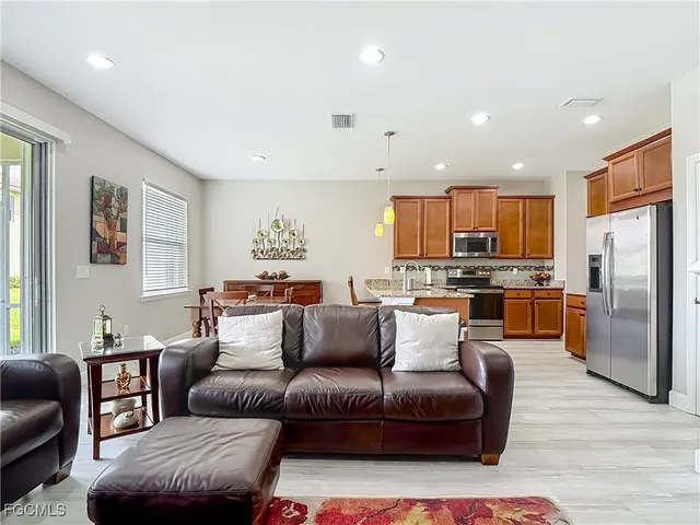 a living room with furniture and kitchen view