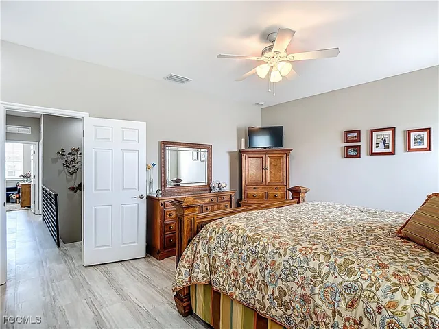 a bedroom with a large bed and a chandelier