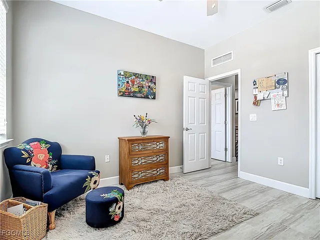 a view of a workspace with furniture and wooden floor