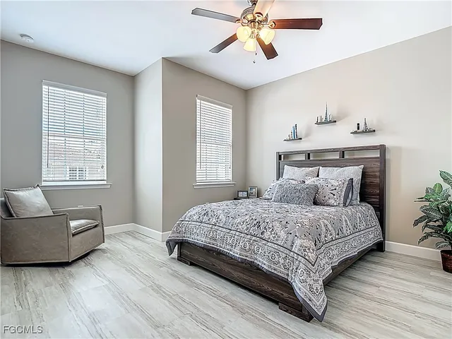 a bedroom with a large bed and a chandelier
